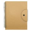 A tan spiral-bound notebook with a circular fastener on the front cover and a textured finish.