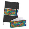 A black notebook featuring a colourful patterned sleeve. The notebook includes an elastic strap and ribbon bookmark.