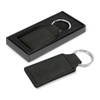 A green faux leather key ring with a silver metal ring, displayed in a black box.