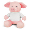 A pink pig plush toy with a soft texture and dressed in a white shirt sits upright. It has a friendly expression and rounded features.