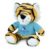 A plush toy tiger with orange and black stripes, wearing a light blue shirt and featuring a logo on it.