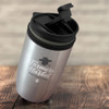 A double wall cup in silver with a black lid and green accent, featuring a logo on the side.