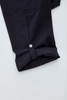 A pair of navy women's cargo pants featuring a rolled cuff and button detail.