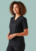 A black women's scrub top with a v-neck and short sleeves, featuring a logo on the fabric.