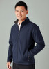 A navy soft shell jacket with a zip front, side pockets, and a collar, worn by a smiling male model.