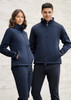 A navy softshell jacket featuring zip pockets and a high collar, worn by a man and a woman. The image has a subtle background.