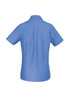 A short-sleeve women's chambray button-up shirt in light blue with a simple design and a logo on the back.