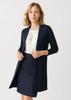A longline cardigan in navy blue, featuring a open front and long sleeves, paired with a white top and skirt.