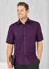 A plain short sleeve shirt in a rich purple colour with a button-up front and a pocket, featuring a logo.