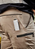 Men's Streetworx stretch pants in beige with a side pocket holding a measuring tool. Includes branding on the waistband.