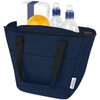 A navy cooler tote holds two drink bottles, an orange, and a white container, featuring black handles and a logo.