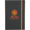 A black journal with an orange elastic band and a logo on the cover.