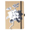 A journal featuring a kraft cover with a floral design in black and white, secured with a black elastic band.