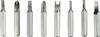 A collection of eight metallic screwdriver bits in varying shapes and sizes, arranged in a row.