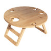A round bamboo picnic table featuring four cup holders and a folding design. It has a natural finish.