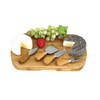 A wooden cheeseboard featuring two types of cheese, grapes, strawberries, and four stainless steel cheese knives with wooden handles.