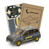 A wooden model of a hatchback car in grey, featuring a logo and accompanied by assembly parts and instructions.