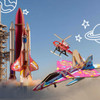 A vibrant wooden model of a rocket ship in red and gold, surrounded by illustrated planets and aircraft in various colours.