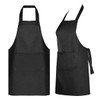 A black apron with a front pocket and adjustable neck straps. It has a simple and sleek design.