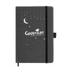 A black recycled leather notebook with a moon and star design, featuring an elastic closure and a logo.