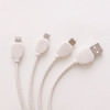 A round-shaped charging cable in white, made from wheat straw, featuring multiple connectors for various devices.