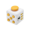 A white fidget cube featuring yellow buttons and a silver ball, designed for tactile engagement.