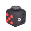 A black fidget cube with red buttons and a silver ball, featuring various tactile surfaces for interaction.