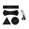 A set of black sticky nano rubber pads in various shapes, including a circle, triangle, rectangle, and curved form, with a phone resting on one.