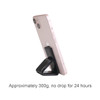 A pink smartphone secured on a black sticky nano rubber pad, angled upright for support.