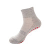 A pair of grey crew socks with a non-slip red grip pattern on the sole. Features a smooth texture and mid-calf height.