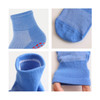 Four angles of blue socks featuring a textured design and grip detail on the sole, along with a snug cuff.