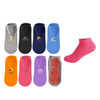 A variety of low cut kids gripper socks in grey, black, navy, orange, purple, and pink, featuring different logos.