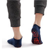 Low cut gripper socks in navy blue with a non-slip pattern on the sole, worn with grey joggers.