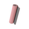 A rolled premium TPE yoga mat in pink and grey, featuring a textured surface and a logo.