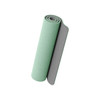 A rolled premium TPE yoga mat in a light green colour with a grey underside. The mat has a textured surface and a logo.