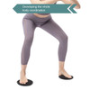 A pair of black yoga sliding disks on a white background, with a person performing a stance wearing grey leggings.