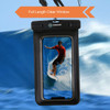 A waterproof phone bag with a clear front, featuring a black design and an attached strap, set against a wave background.