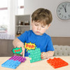 A child interacts with colourful Puzzle Shape Pop It Fidget Toys in purple, green, and orange, showcasing their tactile features.