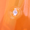 An orange inflatable chair with a clear valve in the centre for inflation and deflation.