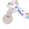 A silver medal with a drop-shaped design, attached to a white ribbon featuring colourful branding.