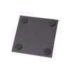 A square black slate coaster with rounded corners and four rubber feet on the underside.