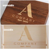 A wooden box with a logo, featuring a smooth, light-coloured interior and a darker exterior.