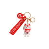 A white and red custom-shaped PVC keyring featuring a cat design, attached to a keychain with a red strap.