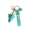 A turquoise custom-shaped PVC keyring with a cute character and a bell attachment. Features a branding tag.