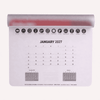 A mouse mat featuring a calendar for January 2027, primarily white with grey and red accents, and includes icons.