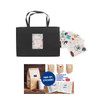 A large black paper bag with a knitted handle, accompanied by various stickers and bags.