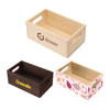 Three wooden storage boxes in light and dark finishes, with cut-out handles and various designs. One features a logo.