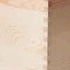 A medium wooden storage box in a natural wood finish, featuring detailed dovetail joints on the corners.
