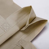 A light beige Kraft paper bag with a laminated finish and woven lining, featuring a textured surface and folded edges.