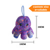 A small, reversible purple octopus plush toy with a sad face. It has a loop for hanging and features a whimsical design.